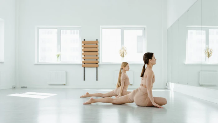 Dancers practising in front of mirror in studio