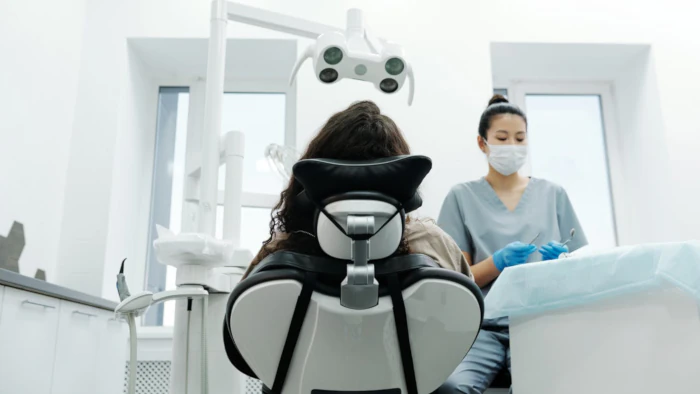 Dentist with patient in clinic