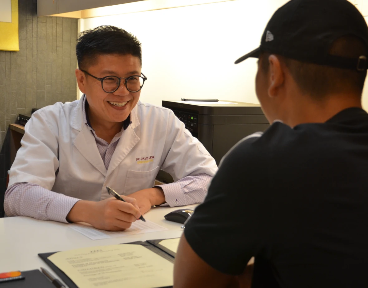 Kirby Poh's chiropractor client speaking with a patient