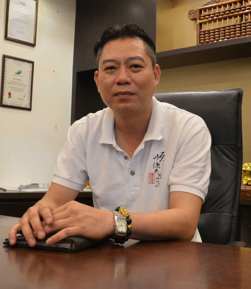 Kirby Poh's carpentry client at his desk