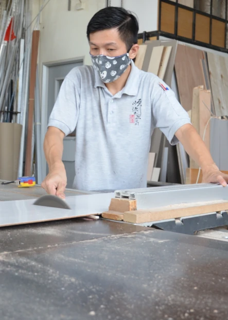Employee of Kirby Poh's carpentry client at work in workshop
