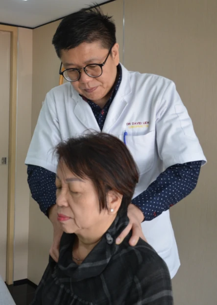 Kirby Poh's chiropractor client performing chiropractic maneuver on patient