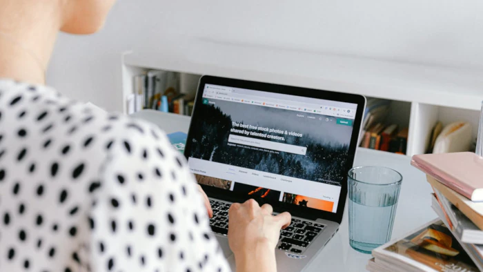 Person browsing Pexels' website on laptop